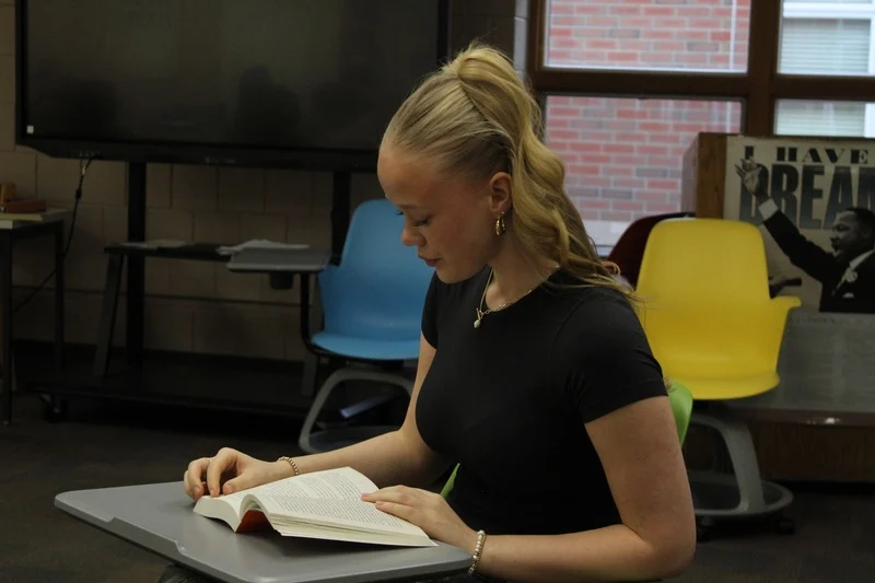 Speech Captain Sophia Amundgaard reads book before the Dec. 22 speech meeting. Amundgaard reads while waiting for other teammates to get there. 