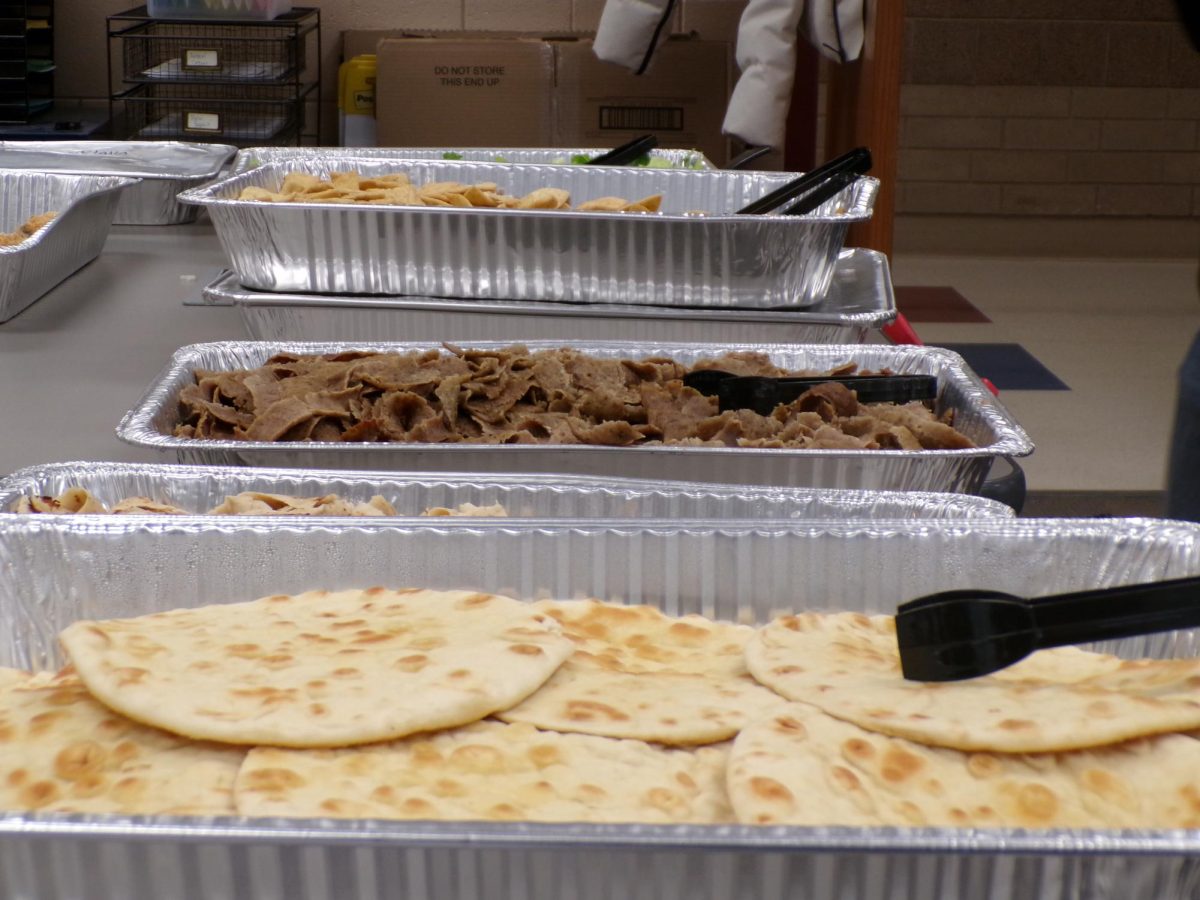 An organized display of pita and seasoned lamb trays, ready for you to build your own gyro. Warm and ready to build your own.