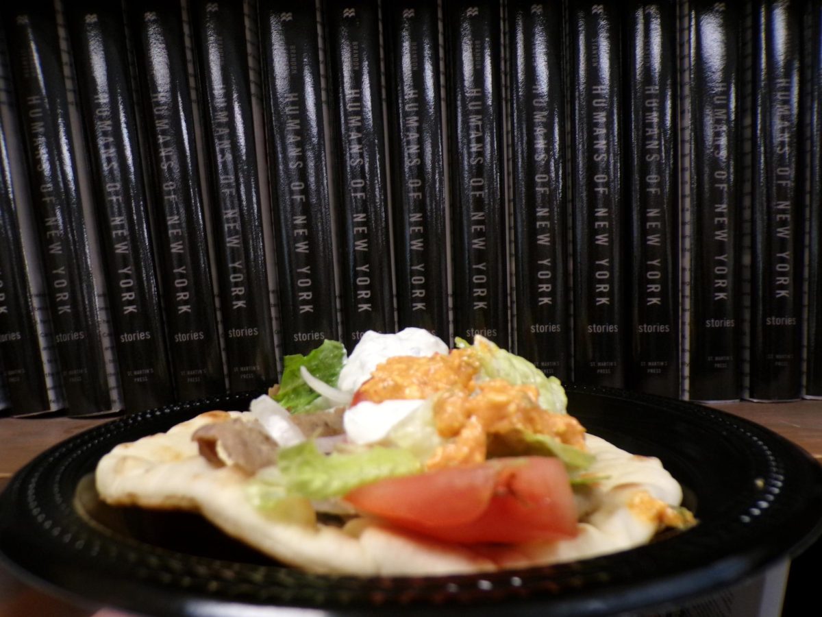Thin slices of grilled gyro meat spill from a pita as creamy tzatziki sauce drips onto the wrapper below. Gyros remain a popular choice for customers seeking a quick, filling meal.