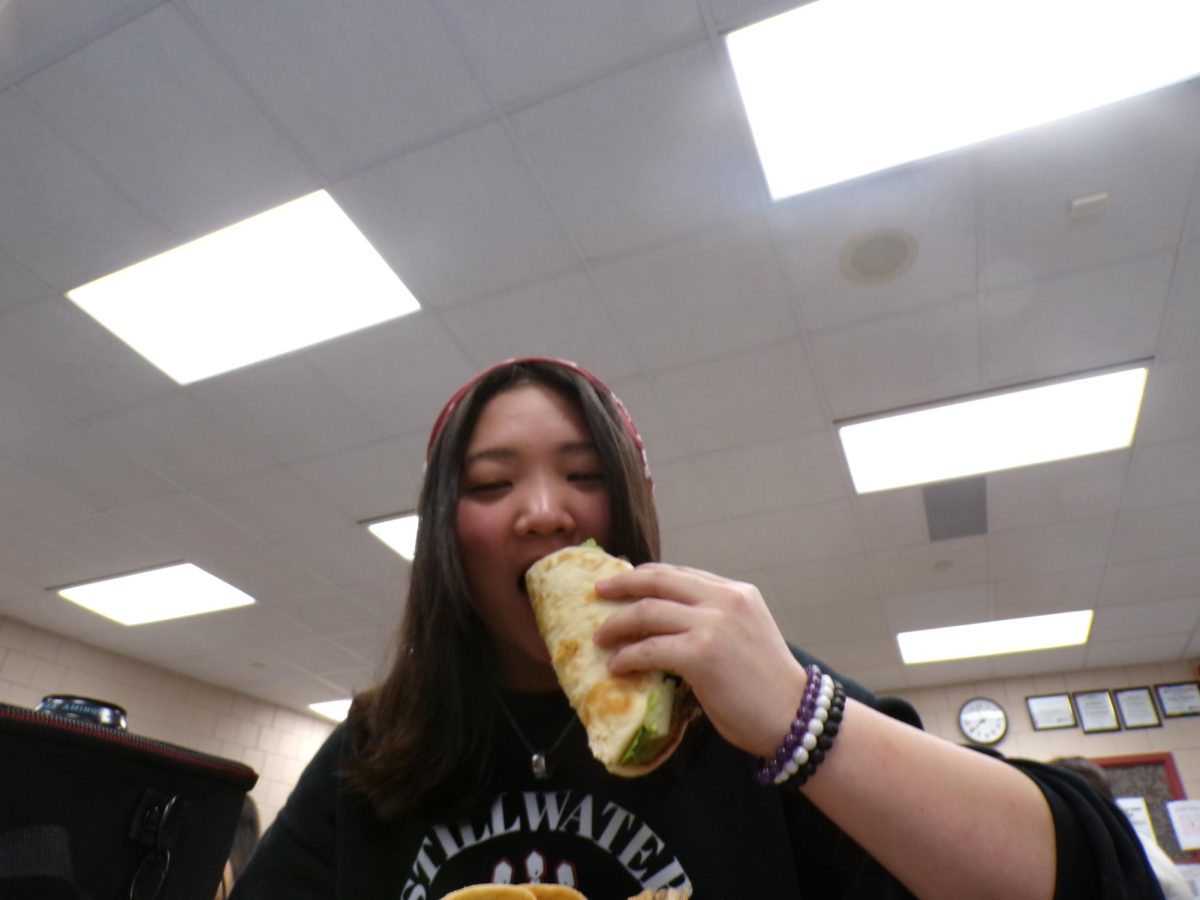 Junior Malia Berg pictured here taste testing Dinos Gyros. Experiencing the complex flavors that make up a Gyro.