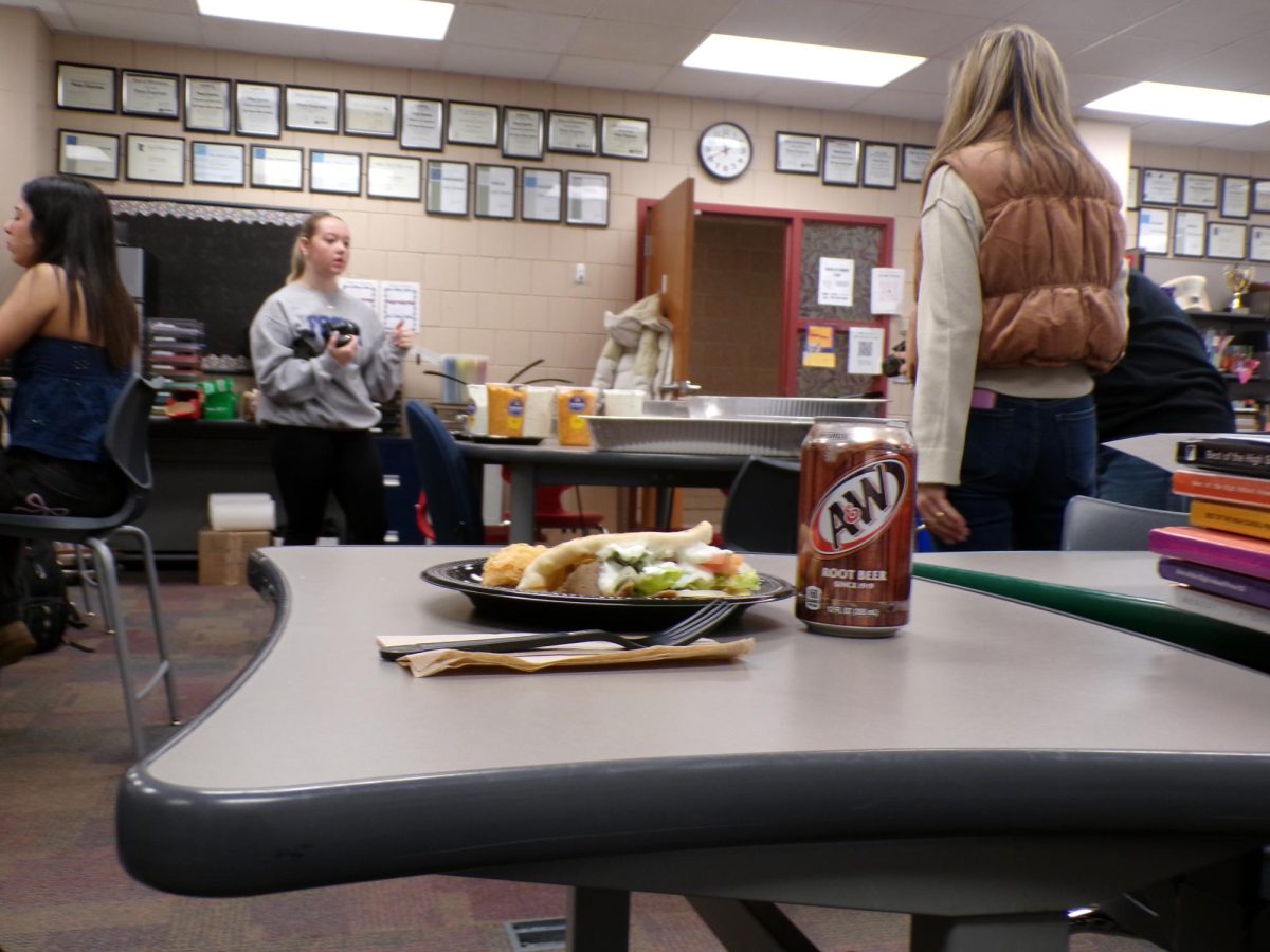 The wide array of food options is present behind a sandwich. A slight warm aroma fills the room.