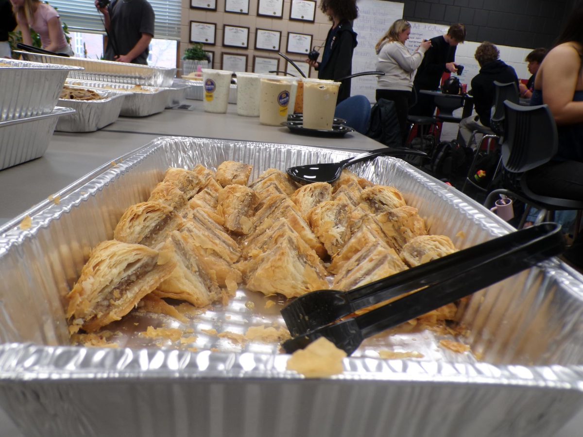 The golden Baklava lines the pan. With its sticky and crunchy textures, it makes a sweet dessert. 