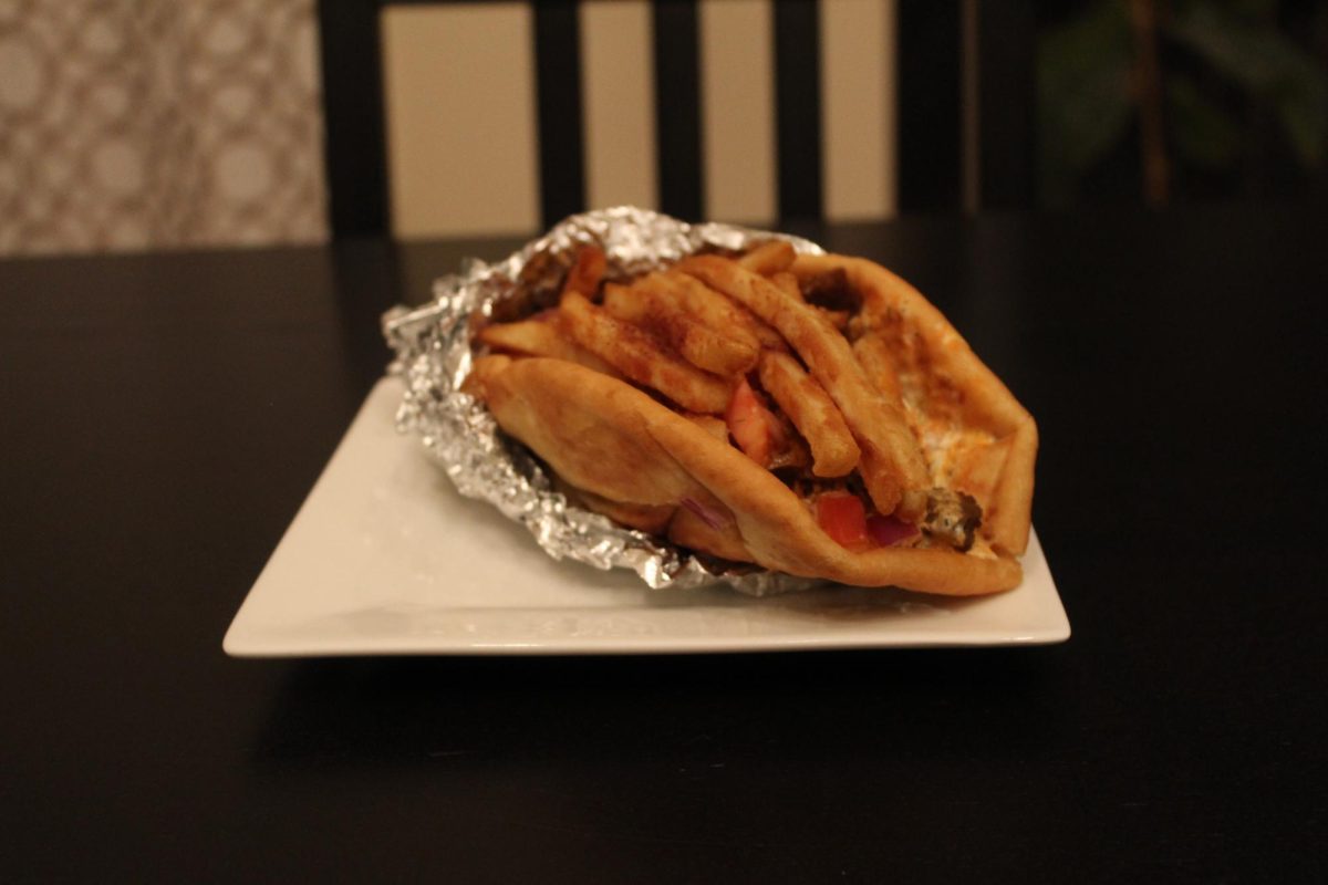 Creamy sauces are drizzled generously through the gyro, peeking out on the sides. You can almost taste the tang and spice just by looking.