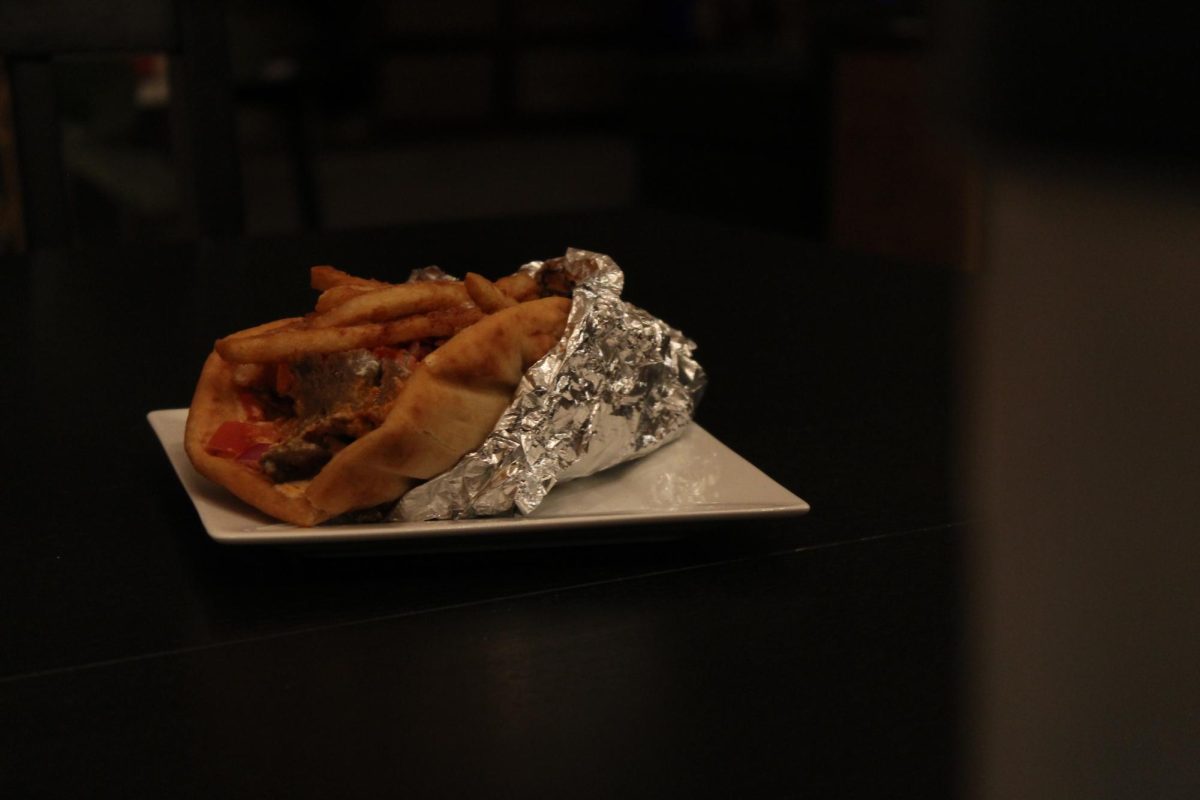 Thinly sliced vegetables peek out from the pita, adding pops of color and crunch. The gyro looks clean, balanced and packed with texture.