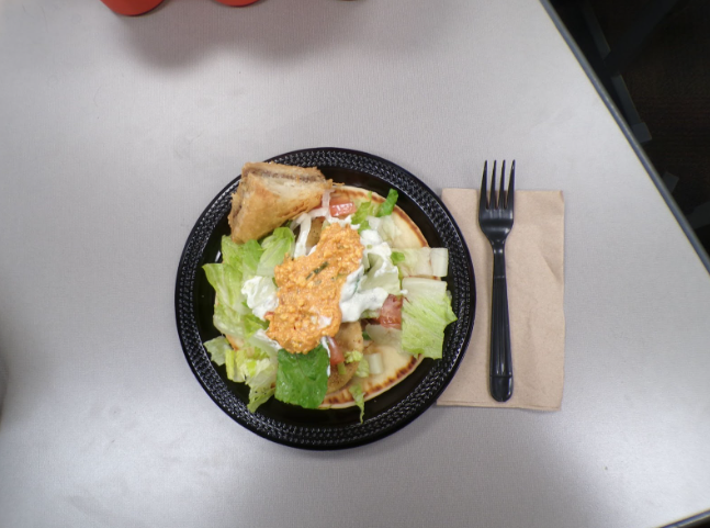 Careful preparation is evident in the clean presentation of the gyro. Each ingredient is layered with purpose and balance.