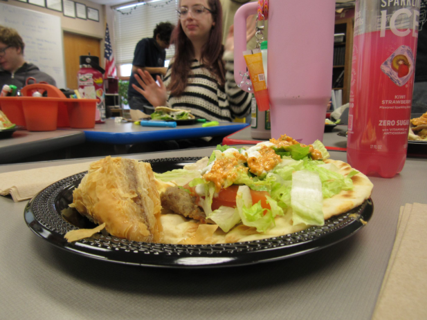 A crispy and flaky slice of baklava with some fresh and crunchy lettuce featured on this gyro.