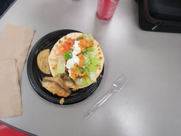This gyro is topped with spicy feta sauce and tzatziki sauce. They add a nice texture to the dry nature of a gyro and a good flavor to complement the lamb.