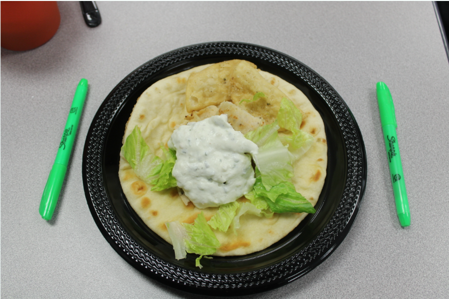 A shot of a gyro sandwich filled with seasoned meat and crisp vegetables on a fluffy pita bread. The gyro had a rich, spiced flavor, mixed with the fresh crunch of the vegetables.