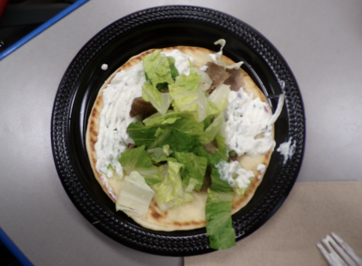 One of Dino’s Gyros’ signature gyros, made to order and served on pita bread.
