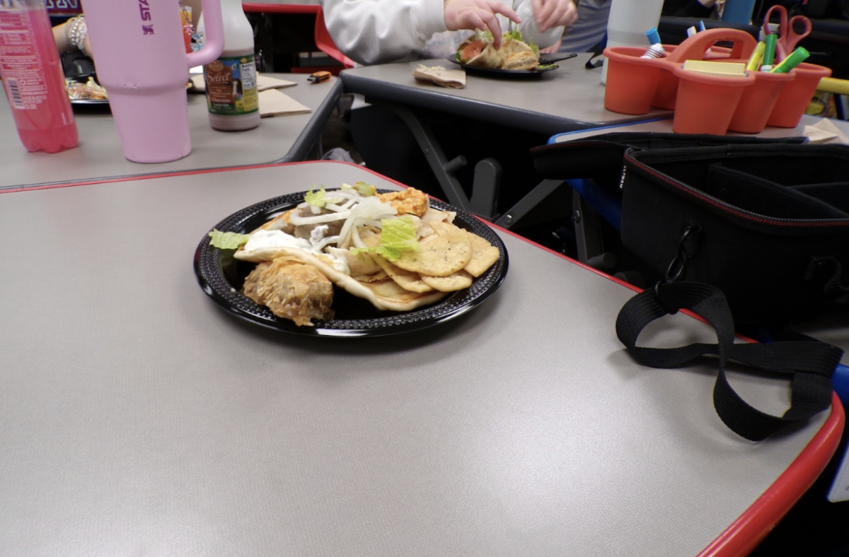 The vibrant colors of the dish contrast against the gray tables and black plates.  All well seasoned with the many ingredients, blending well together.