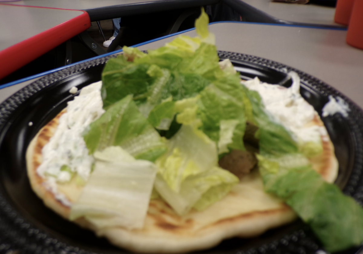 The fresh lettuce adds a crisp, refreshing balance to Dino’s Gyros.
