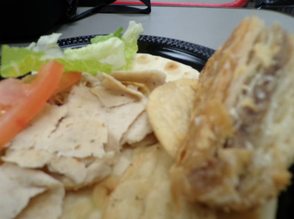 The close shot of the gyro and baklava emphasize the texture and many layers of the wrap. The close scene of the food shows the Greek method of producing the gyro.