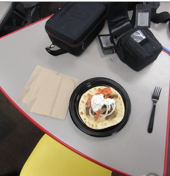 A single gyro is framed perfectly in the shot, wrapped tight and ready to be enjoyed. The focus highlights its fresh ingredients and bold flavor.