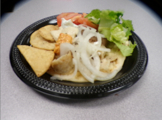 Fresh Tomatoes lettuce and onions sat upon the grilled pita bread. 