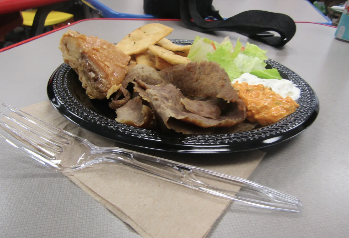 A close-up of Dino’s popular gyro dish, known for its rich flavors and fresh toppings.