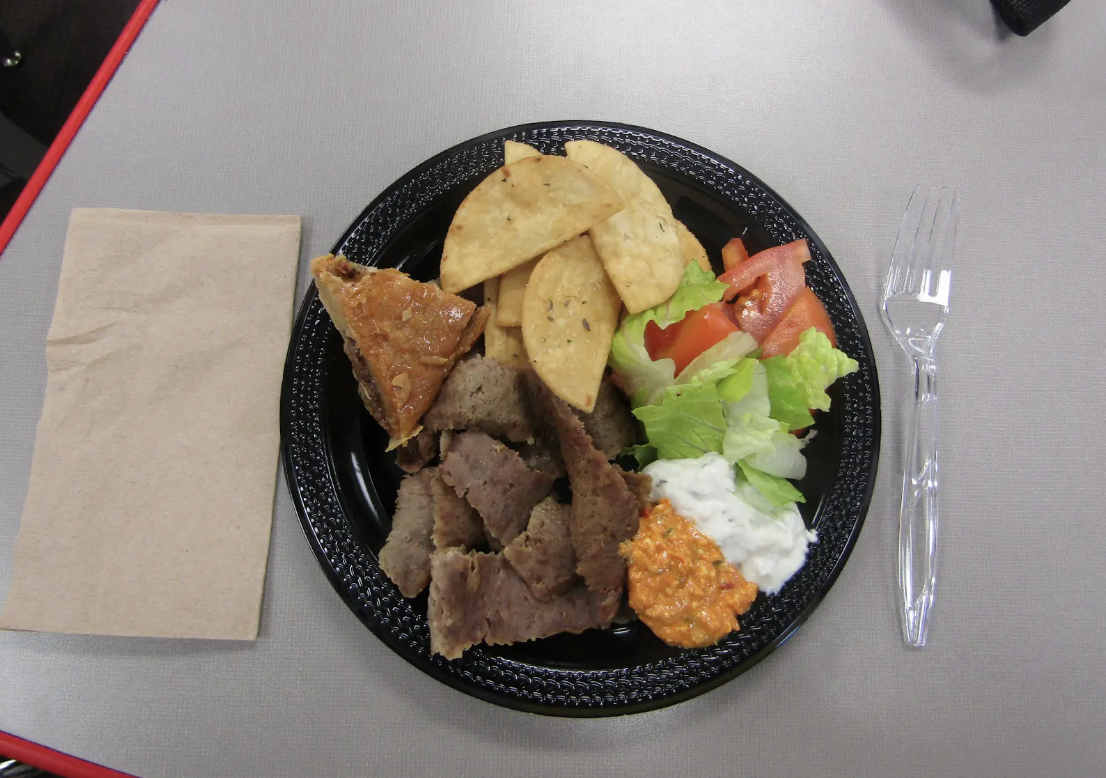 A freshly prepared meal from Dino’s, showcasing both traditional flavors and house-made sides.