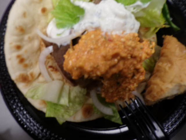 Piled gyro filled with delicious spicy feta and tzatziki. Flavorful ingredients all from Dino's Gyros. 