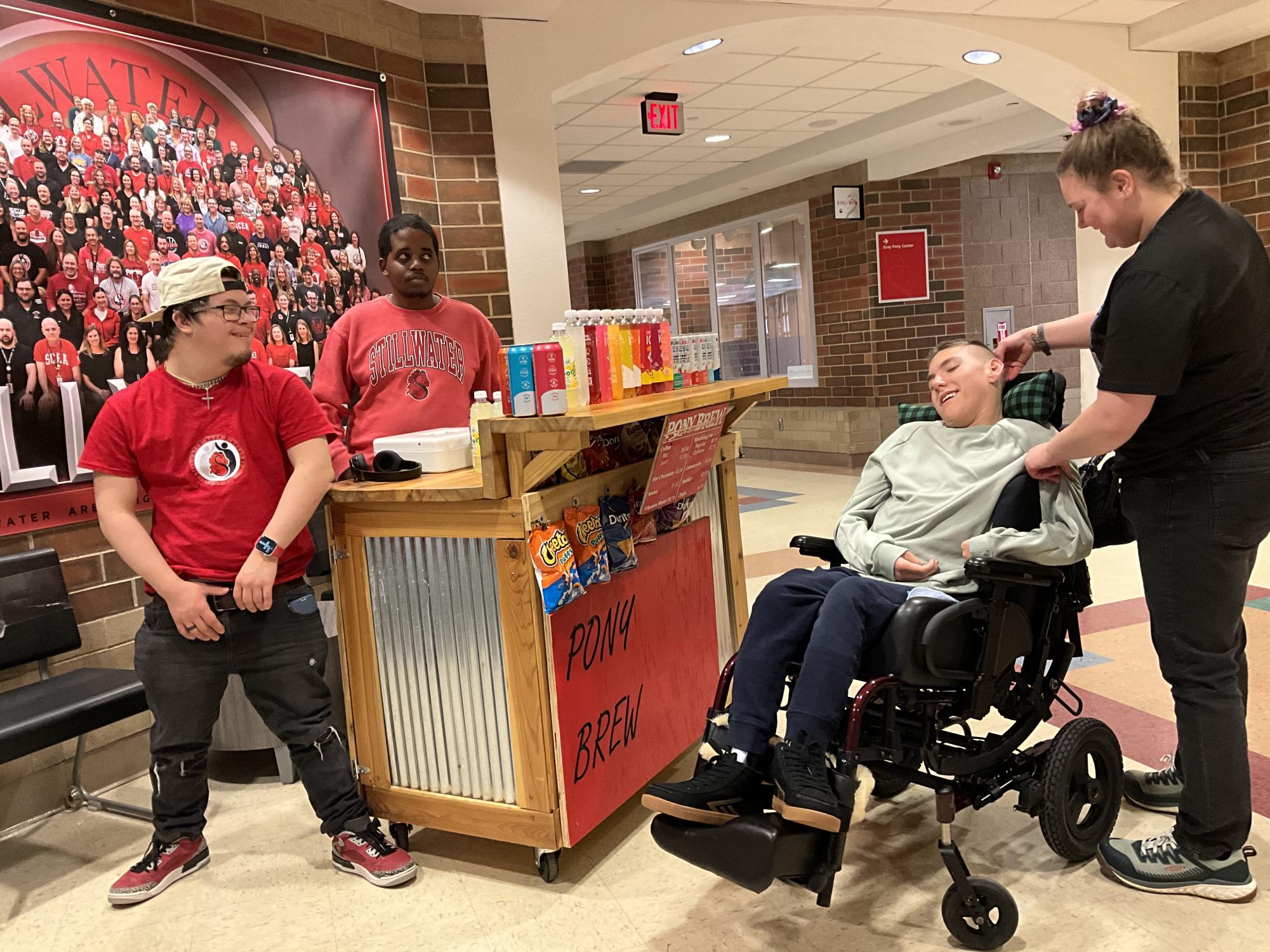 Senior Liam Chau and sophomore Isaiah Setnes run the coffee cart first hour. They  are helping junior Brody Ritchie and his nurse Michaela Larson with their purchase.