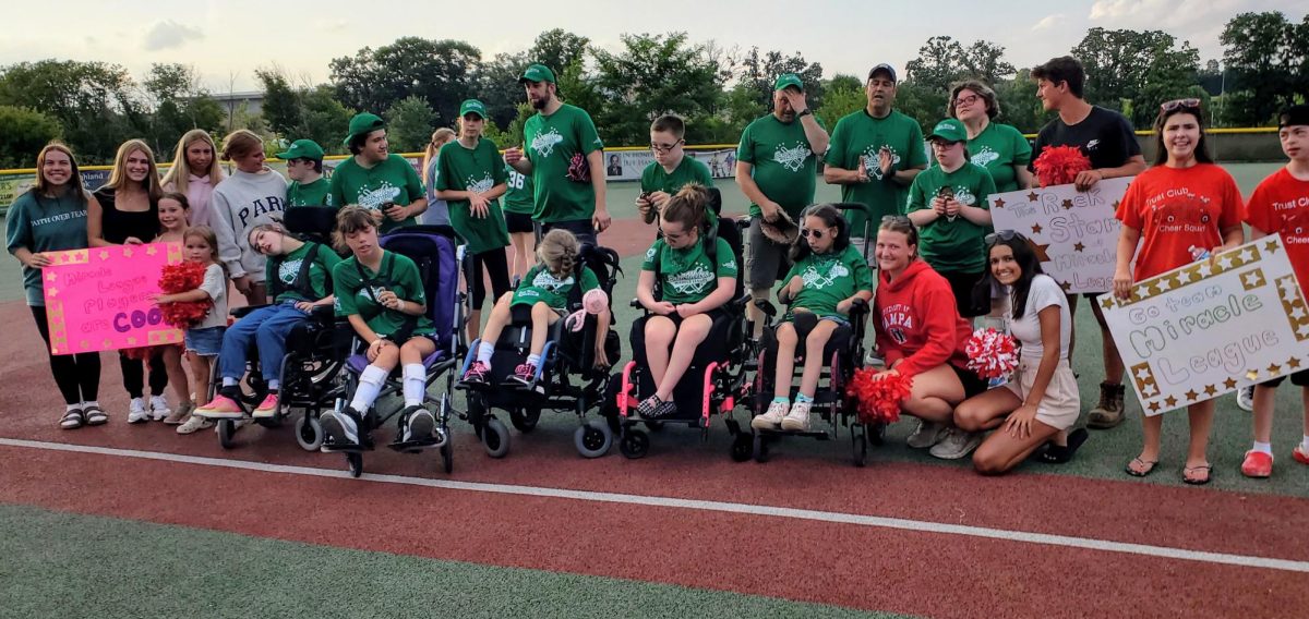 Trust Club and Unified Cheer squad support their friends at the East Metro Miracle League baseball game last summer. They arrived at the field with posters and pom poms to cheer on their friends.